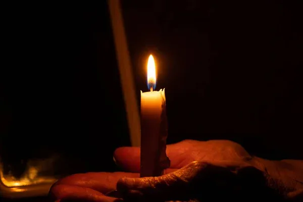 depositphotos_415008802-stock-photo-old-woman-hands-candle-flame