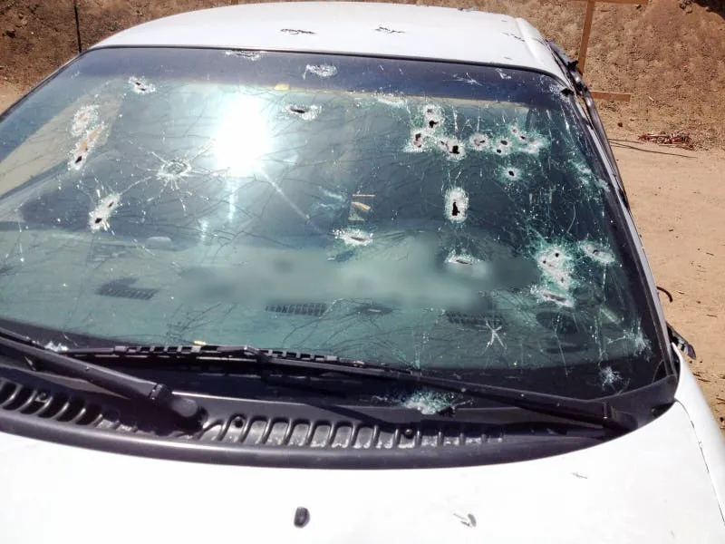 automobile-shot-up-bullet-gun-fire-fight-holes-windshield-broken-glass-automobile-shot-up-bullet-gun-fire-holes-windshield-184871627